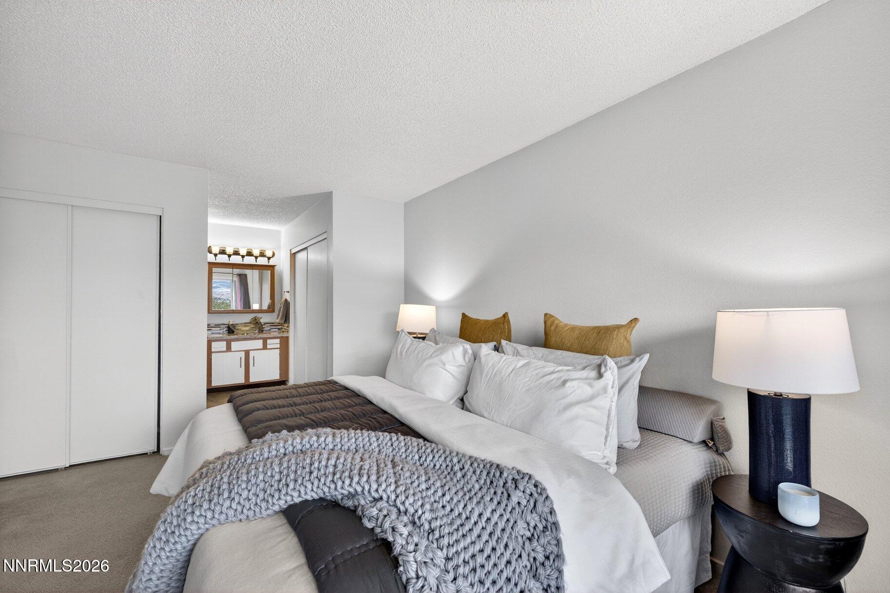 3415 Balboa Drive Reno, NV 89503 - Photo 20 of 61 a bedroom with a bed and a lamp on table