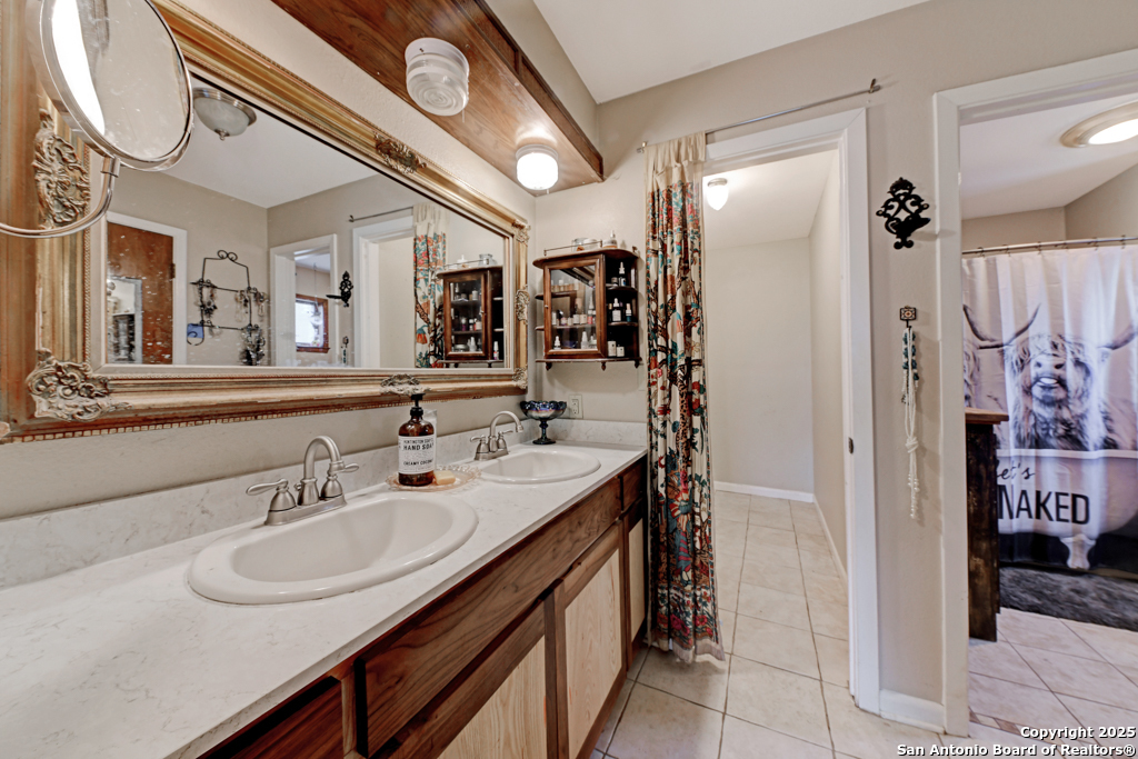 3136 Bolton Road Marion, TX 78124 - Photo 14 of 46 a bathroom with a sink and a mirror