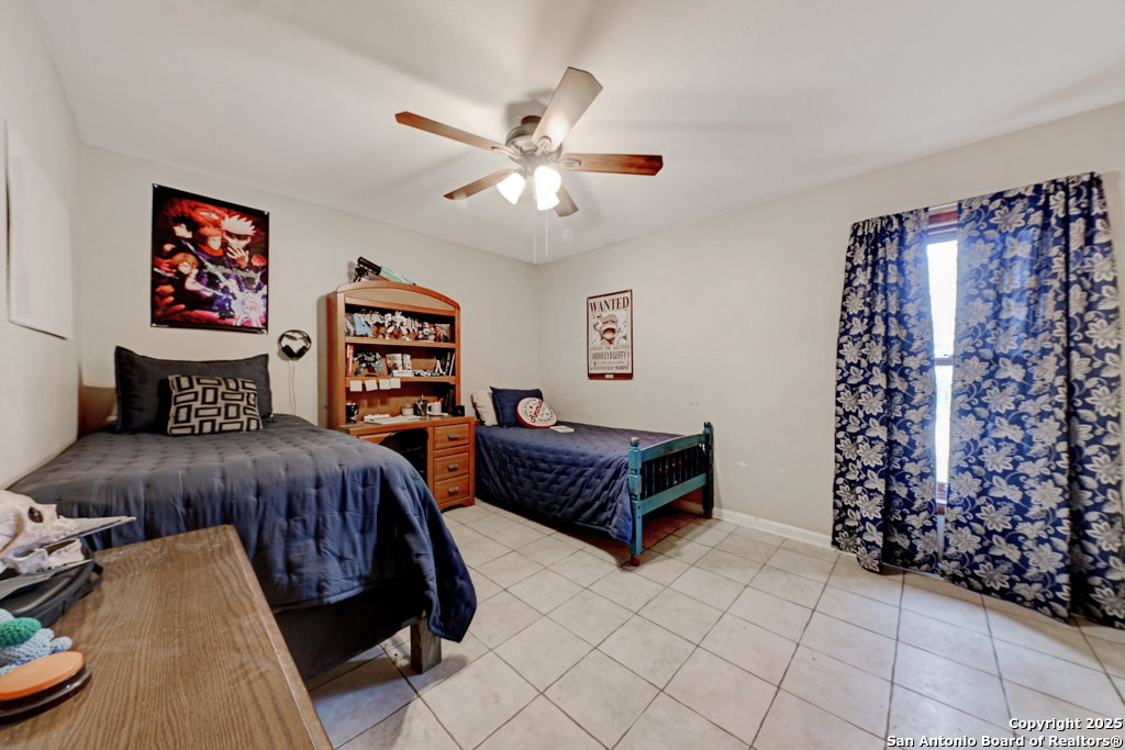 3136 Bolton Road Marion, TX 78124 - Photo 17 of 46 a bedroom with furniture and a chandelier