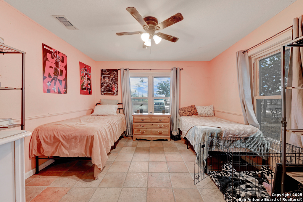 3136 Bolton Road Marion, TX 78124 - Photo 19 of 46 a bedroom with a bed and a large window