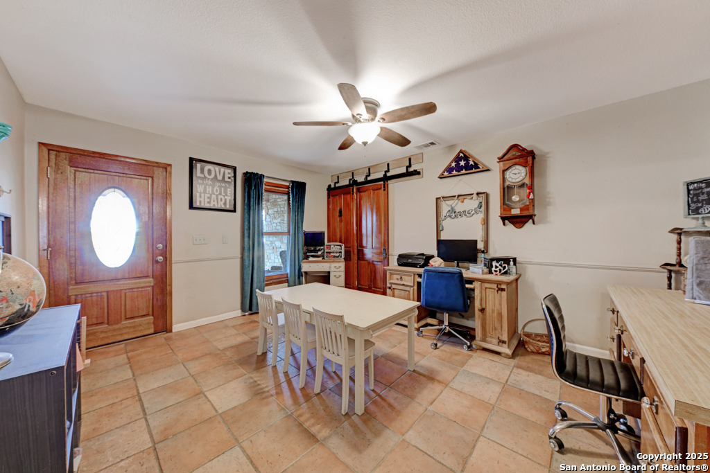 3136 Bolton Road Marion, TX 78124 - Photo 10 of 46 a living room with furniture a dining table and a chandelier