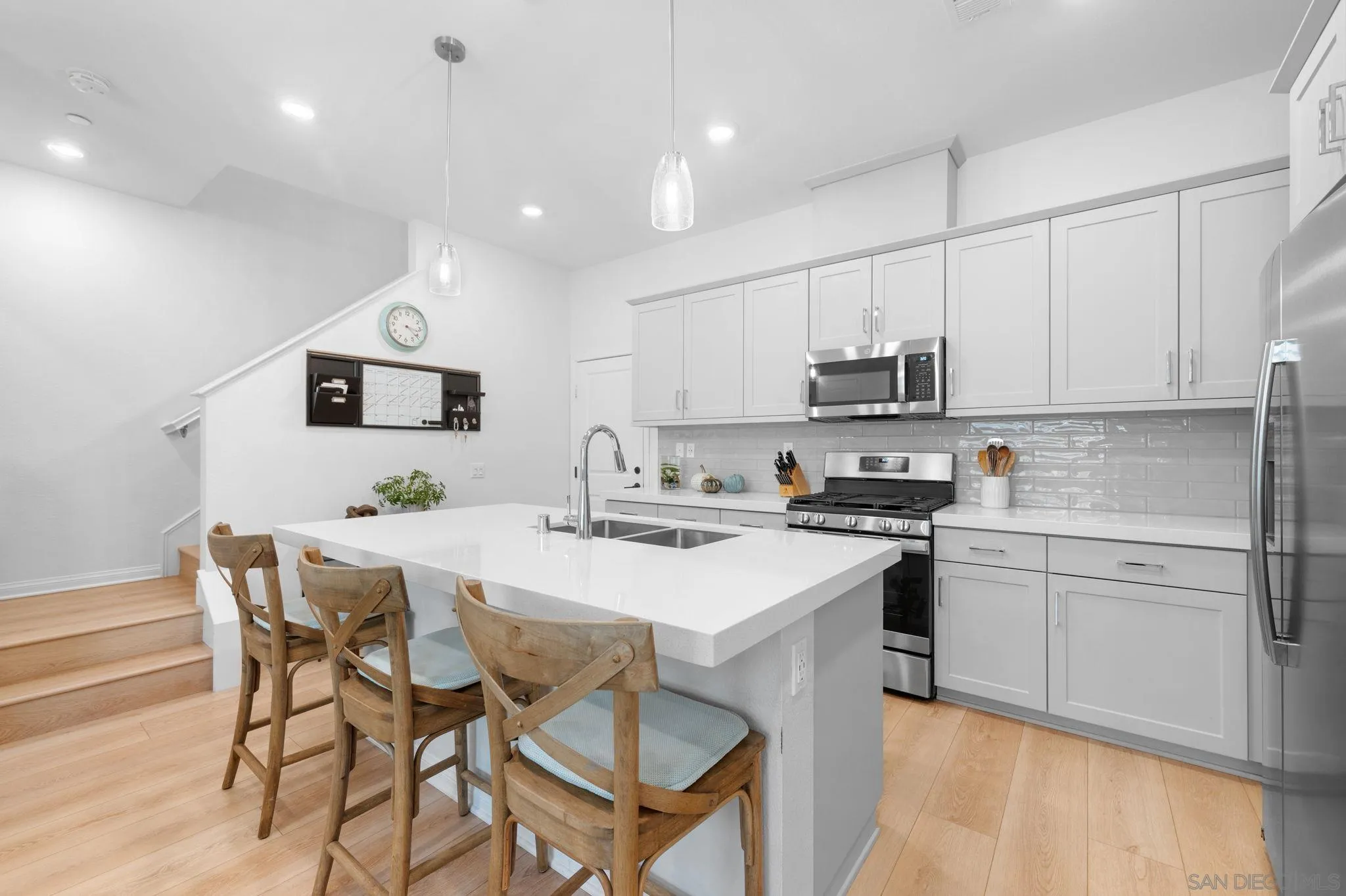2023 Bluestone Circle Chula Vista, CA 91913 - Photo 15 of 51 a kitchen with a sink stainless steel appliances and white cabinets