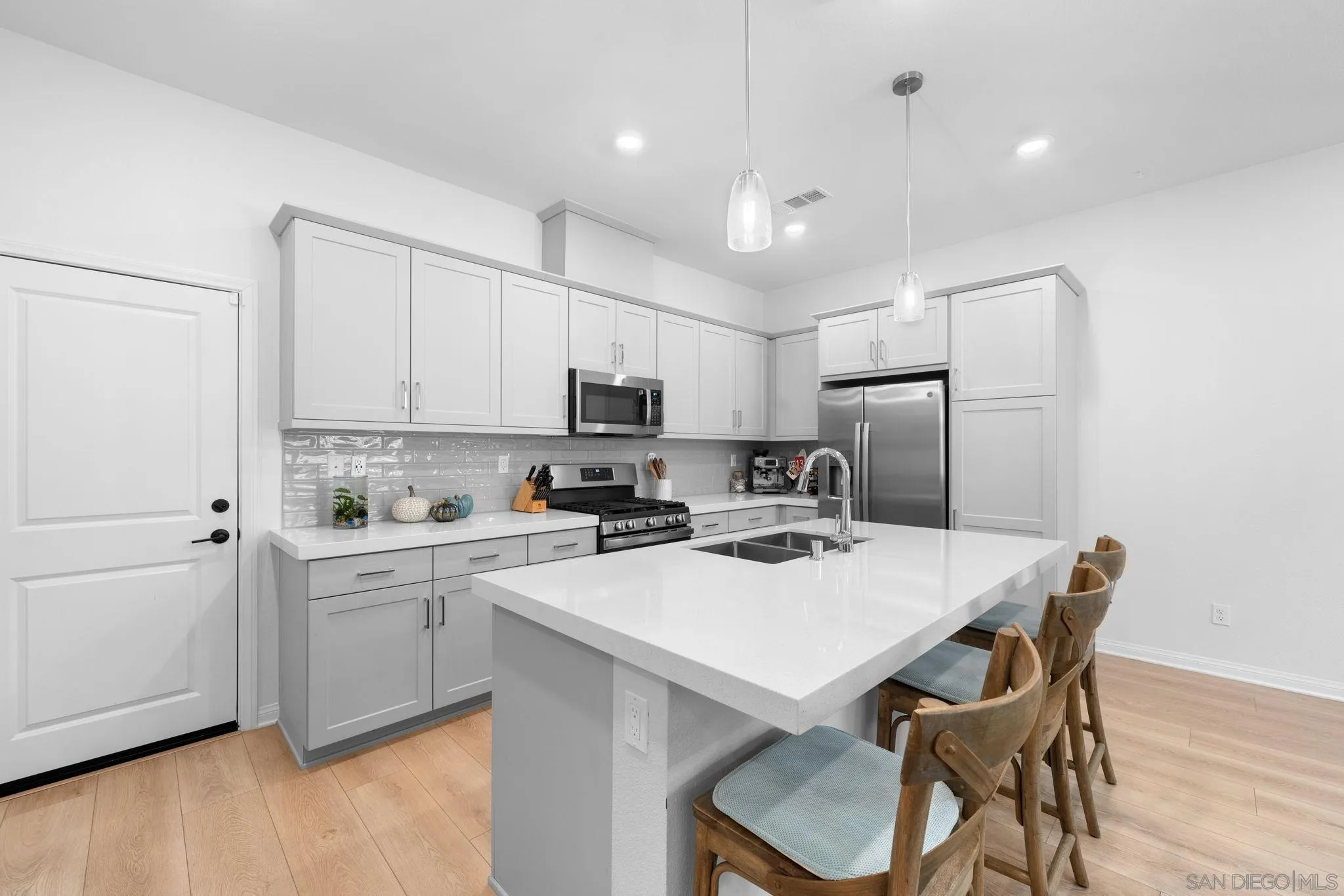 2023 Bluestone Circle Chula Vista, CA 91913 - Photo 17 of 51 a kitchen with a dining table chairs and refrigerator
