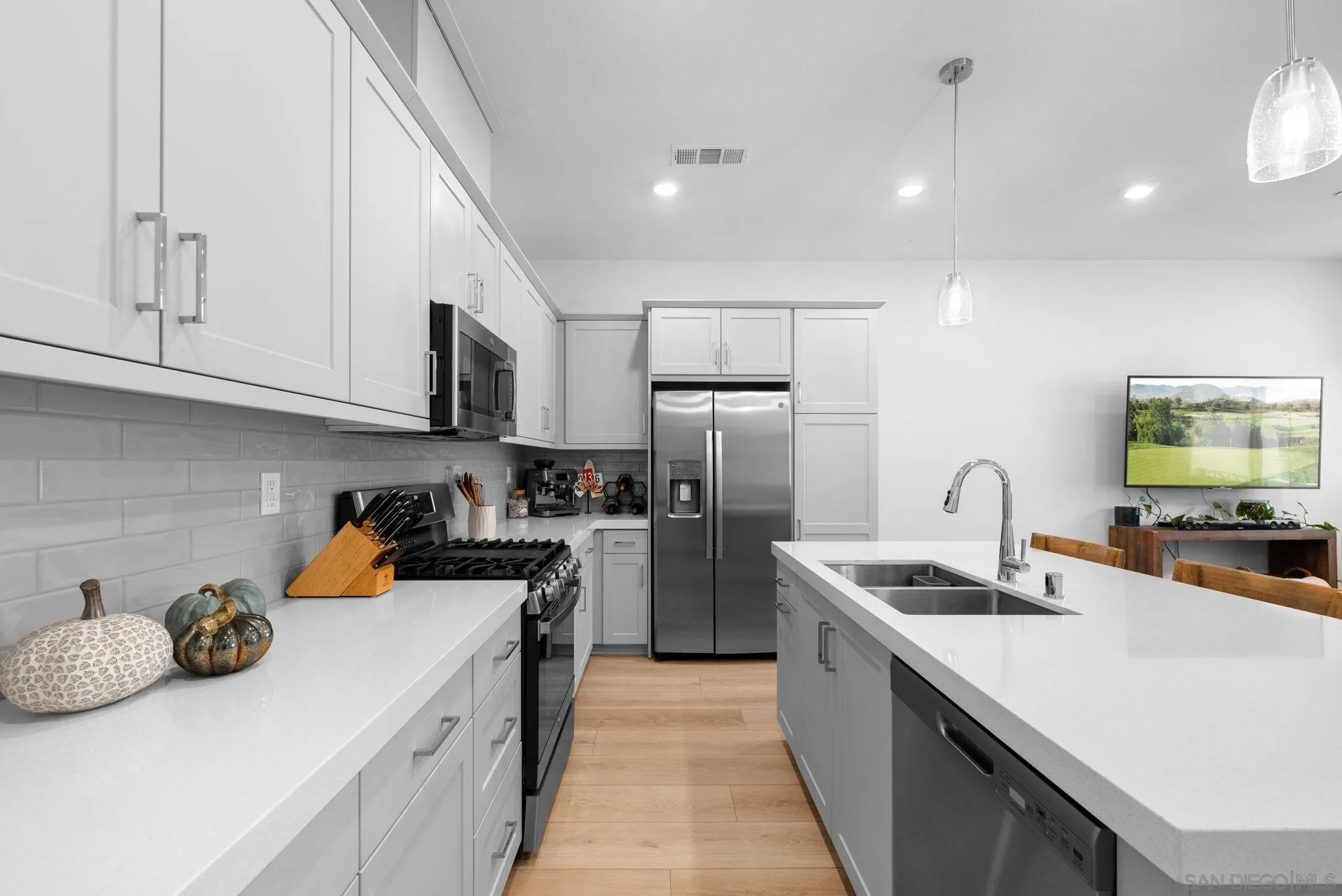 2023 Bluestone Circle Chula Vista, CA 91913 - Photo 18 of 51 a kitchen with refrigerator a sink and a stove