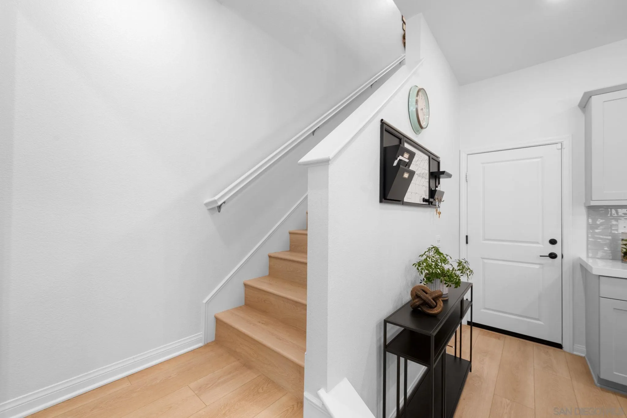 2023 Bluestone Circle Chula Vista, CA 91913 - Photo 21 of 51 a hallway with wooden floor and furniture