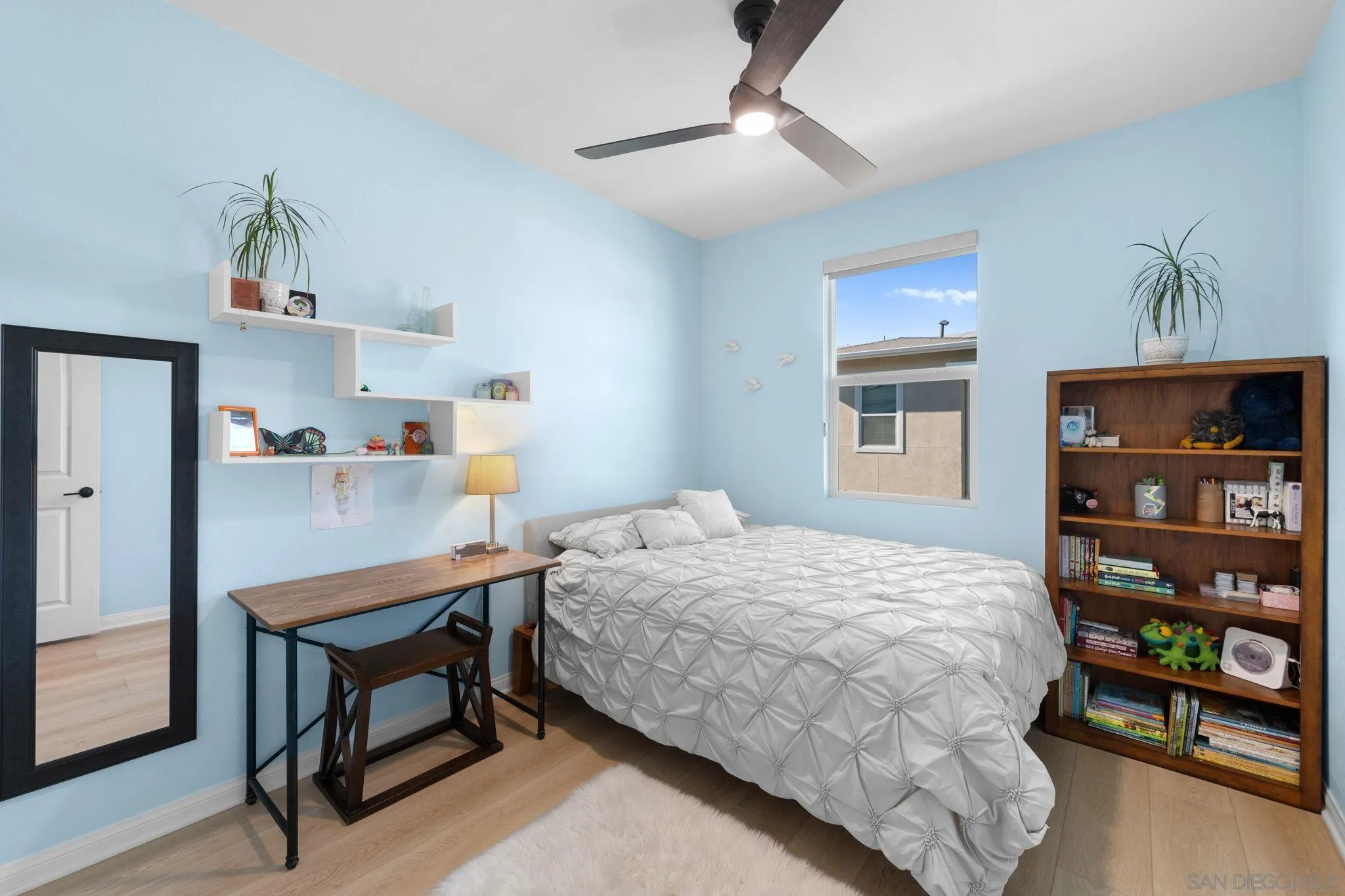2023 Bluestone Circle Chula Vista, CA 91913 - Photo 26 of 51 a bedroom with a bed a table and painting on the wall