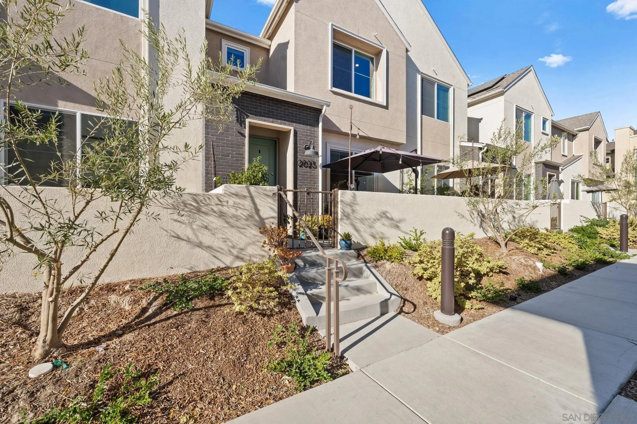 2023 Bluestone Circle Chula Vista, CA 91913 - Photo 3 of 51 a view of a white house with a yard and couches