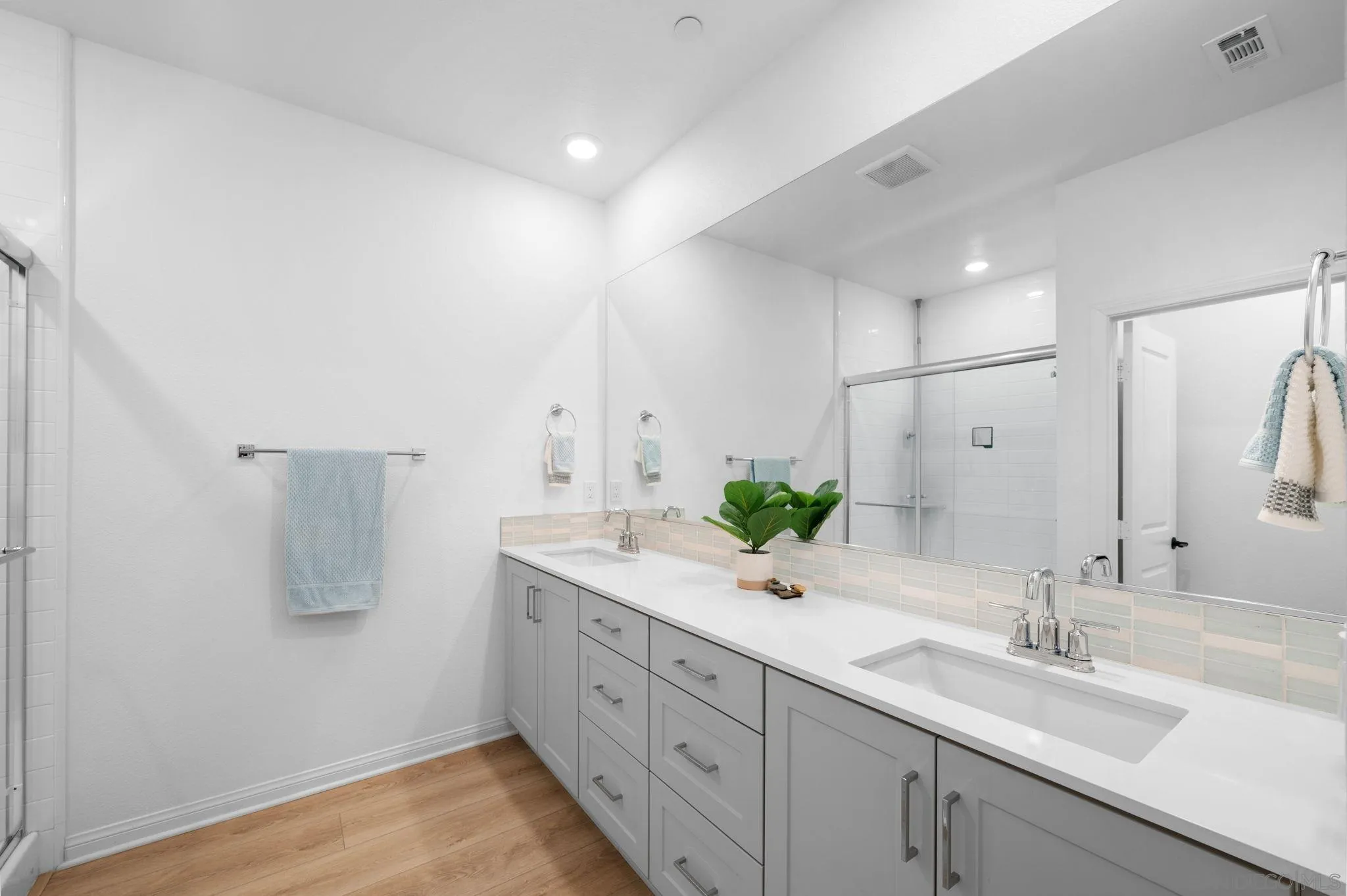 2023 Bluestone Circle Chula Vista, CA 91913 - Photo 33 of 51 a bathroom with a double vanity sink and a mirror