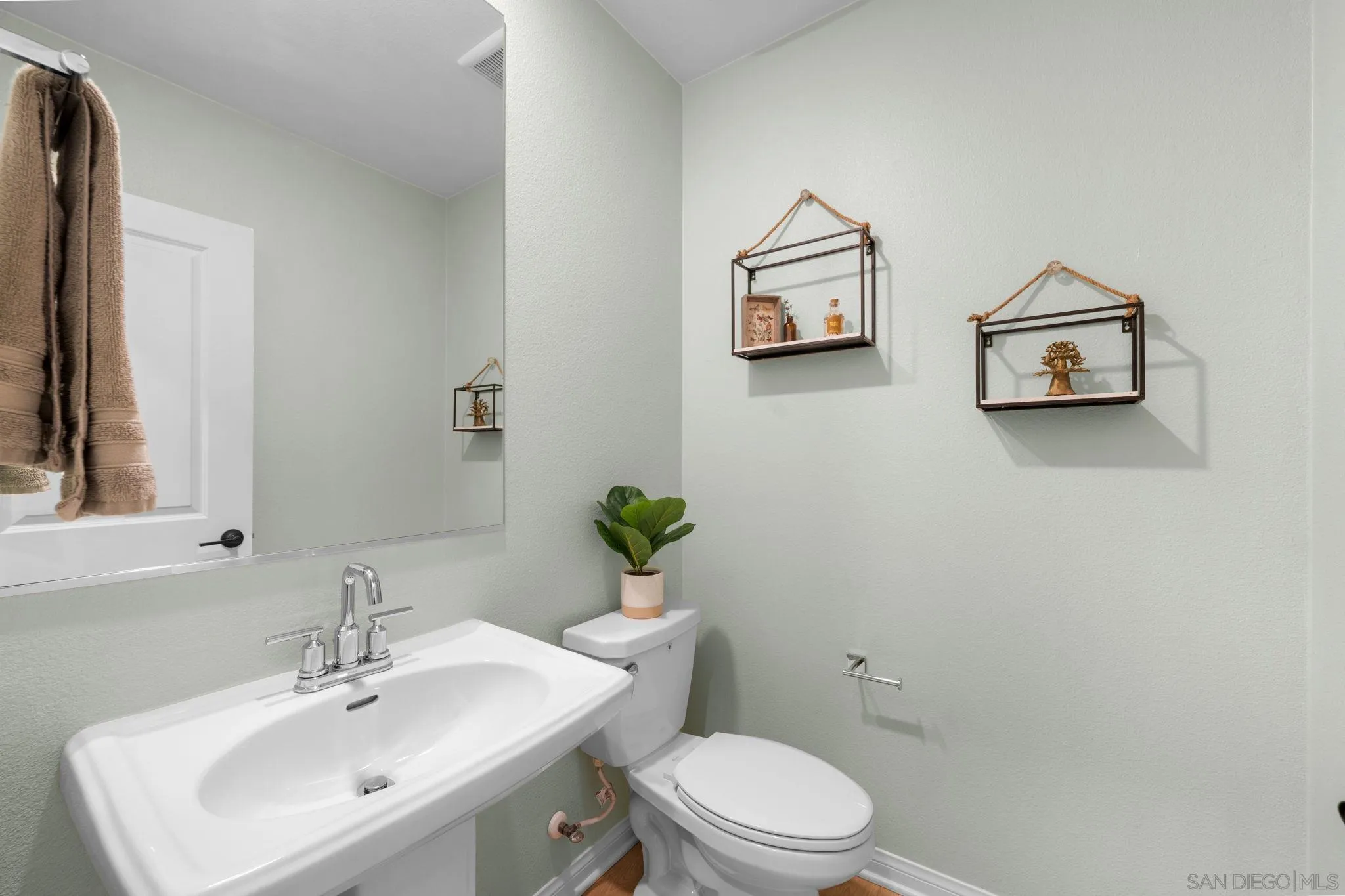 2023 Bluestone Circle Chula Vista, CA 91913 - Photo 38 of 51 a bathroom with a toilet a sink and mirror