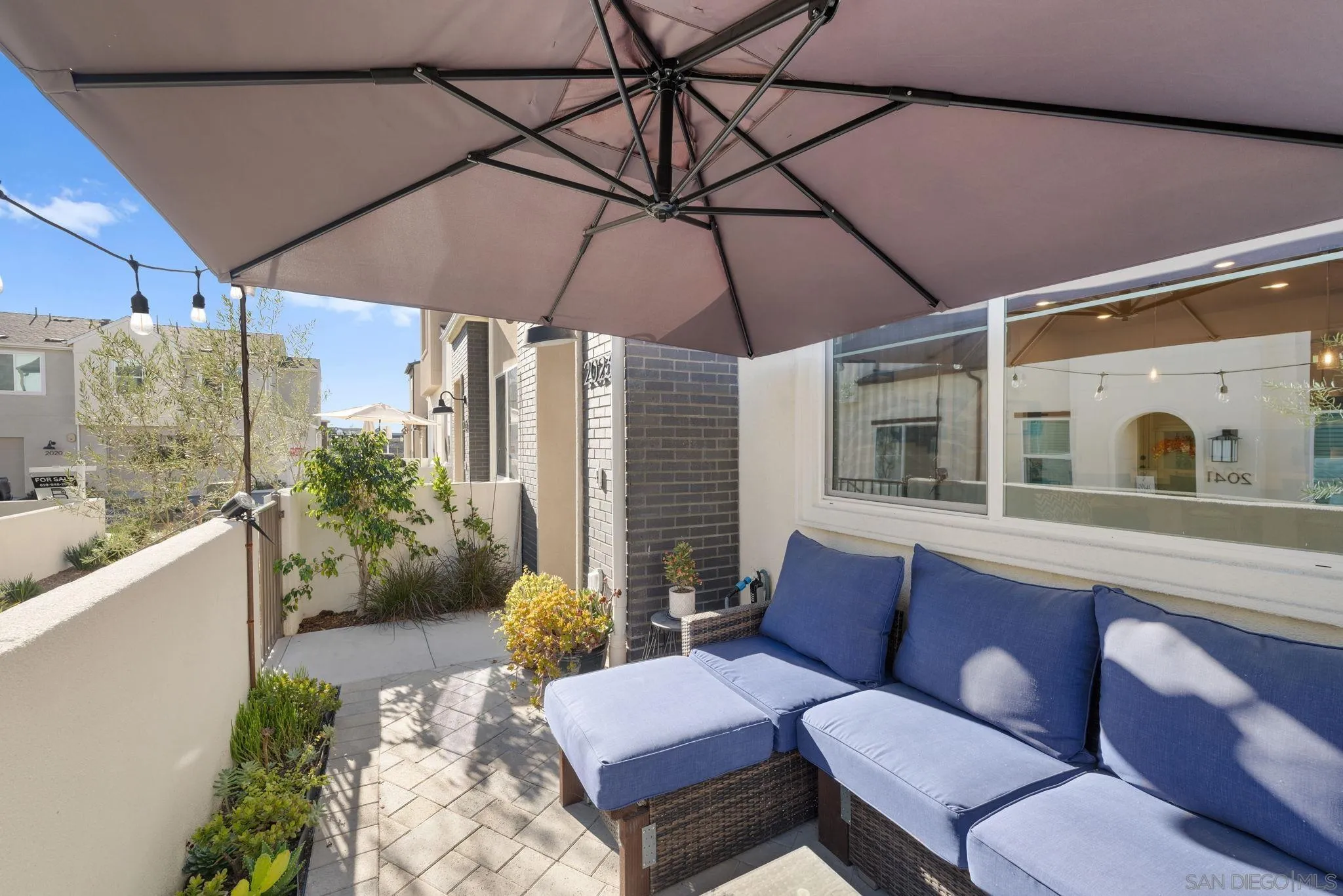 2023 Bluestone Circle Chula Vista, CA 91913 - Photo 4 of 51 a outdoor living space with furniture and umbrella