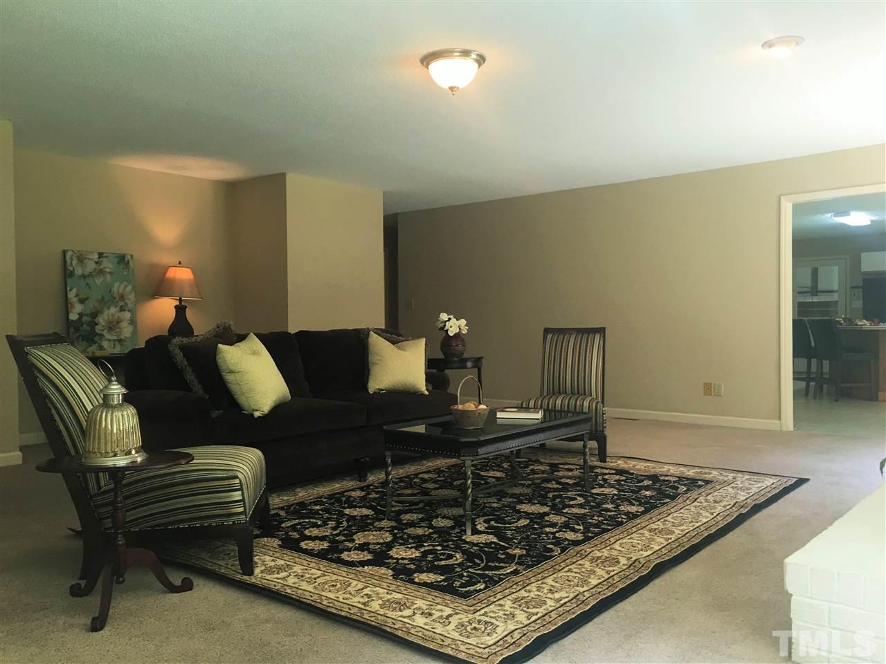 10200 Old Creedmoor Road Raleigh, NC 27613 - Photo 1 of 24 a living room with furniture and a rug
