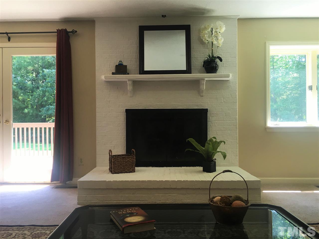 10200 Old Creedmoor Road Raleigh, NC 27613 - Photo 11 of 24 a living room with furniture and a fireplace
