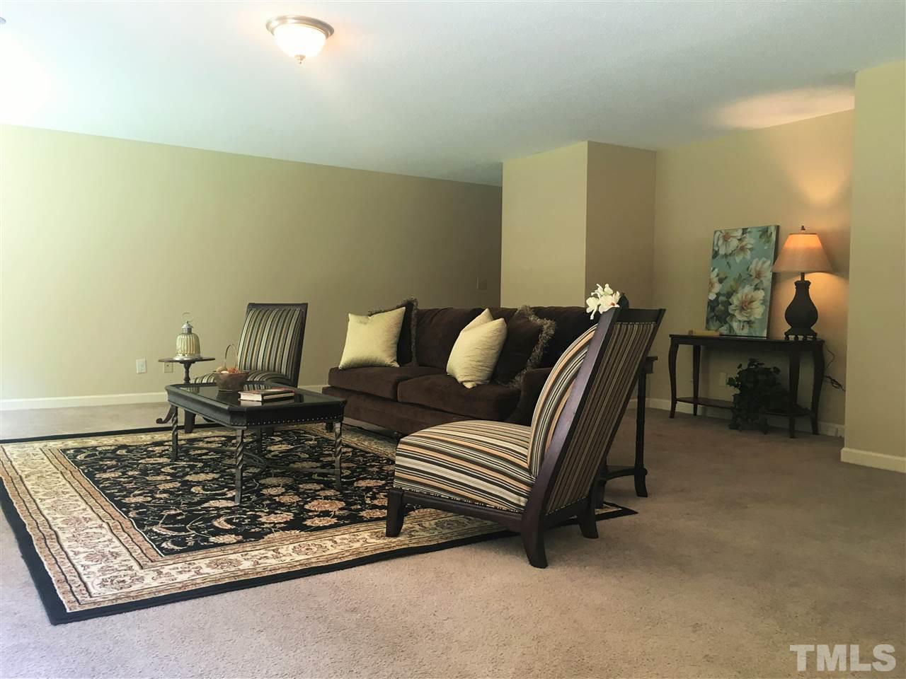 10200 Old Creedmoor Road Raleigh, NC 27613 - Photo 3 of 24 a living room with furniture and a rug