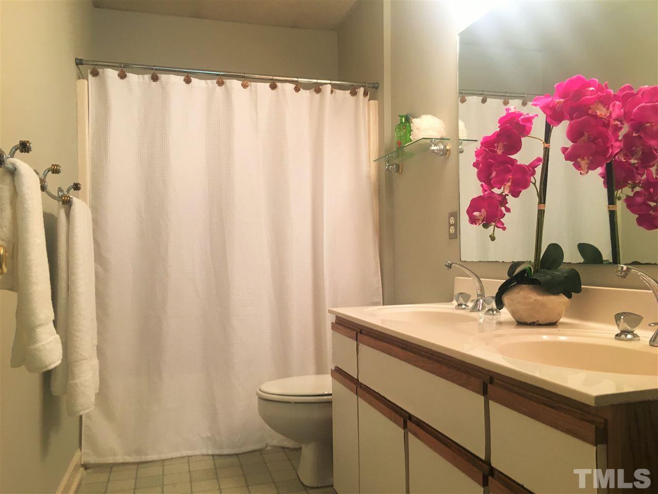 10200 Old Creedmoor Road Raleigh, NC 27613 - Photo 6 of 24 a bathroom with a sink vanity mirror and toilet