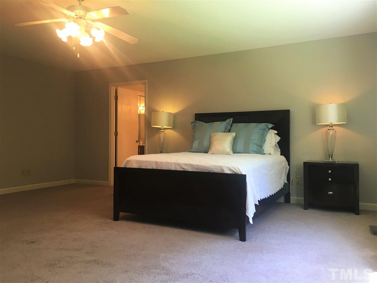 10200 Old Creedmoor Road Raleigh, NC 27613 - Photo 7 of 24 a bedroom with a bed and a night stand