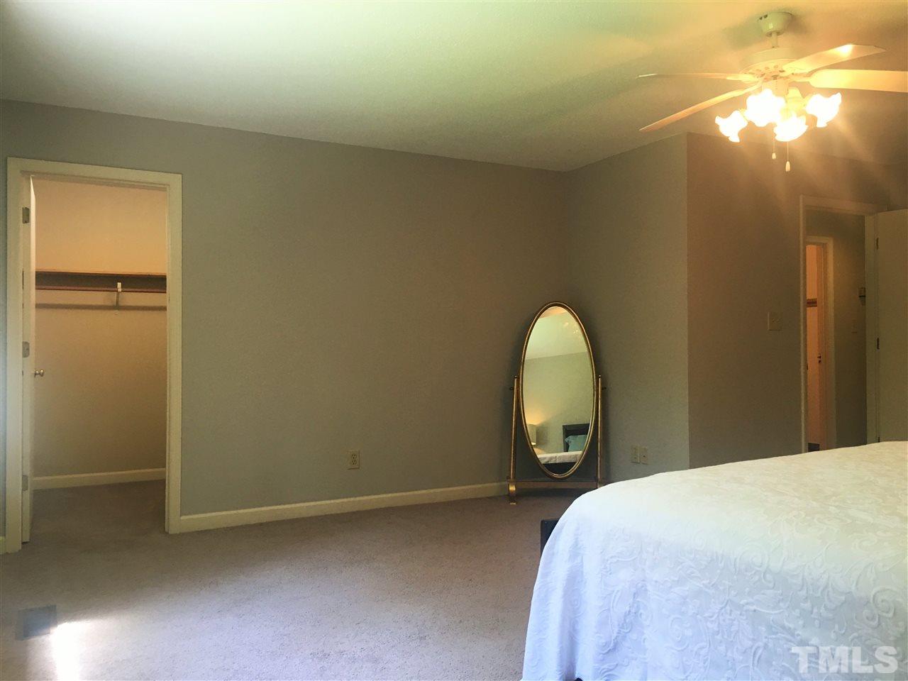10200 Old Creedmoor Road Raleigh, NC 27613 - Photo 8 of 24 a bedroom with a bed and a lamp on desk