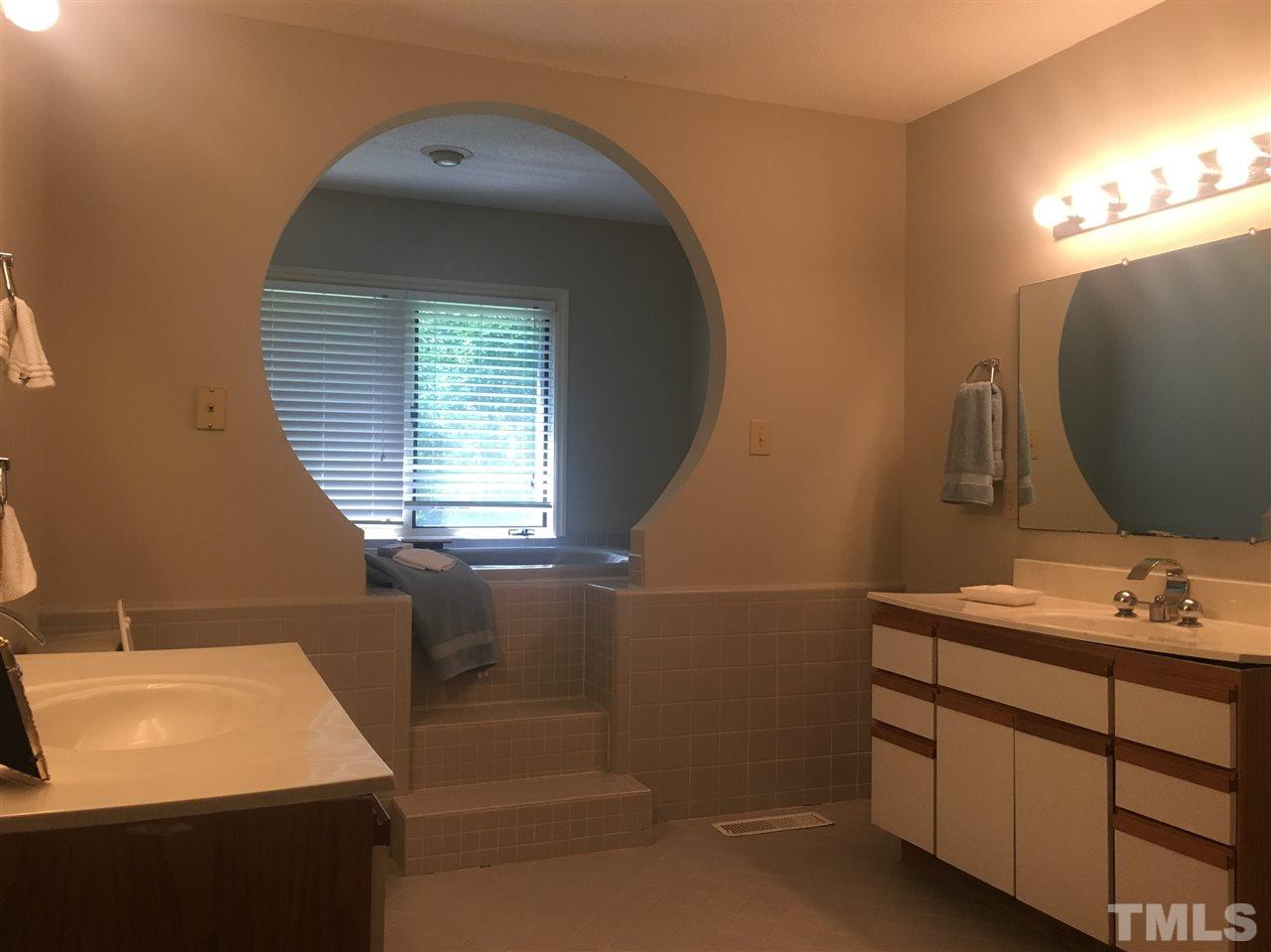 10200 Old Creedmoor Road Raleigh, NC 27613 - Photo 10 of 24 a bathroom with a sink vanity and a mirror