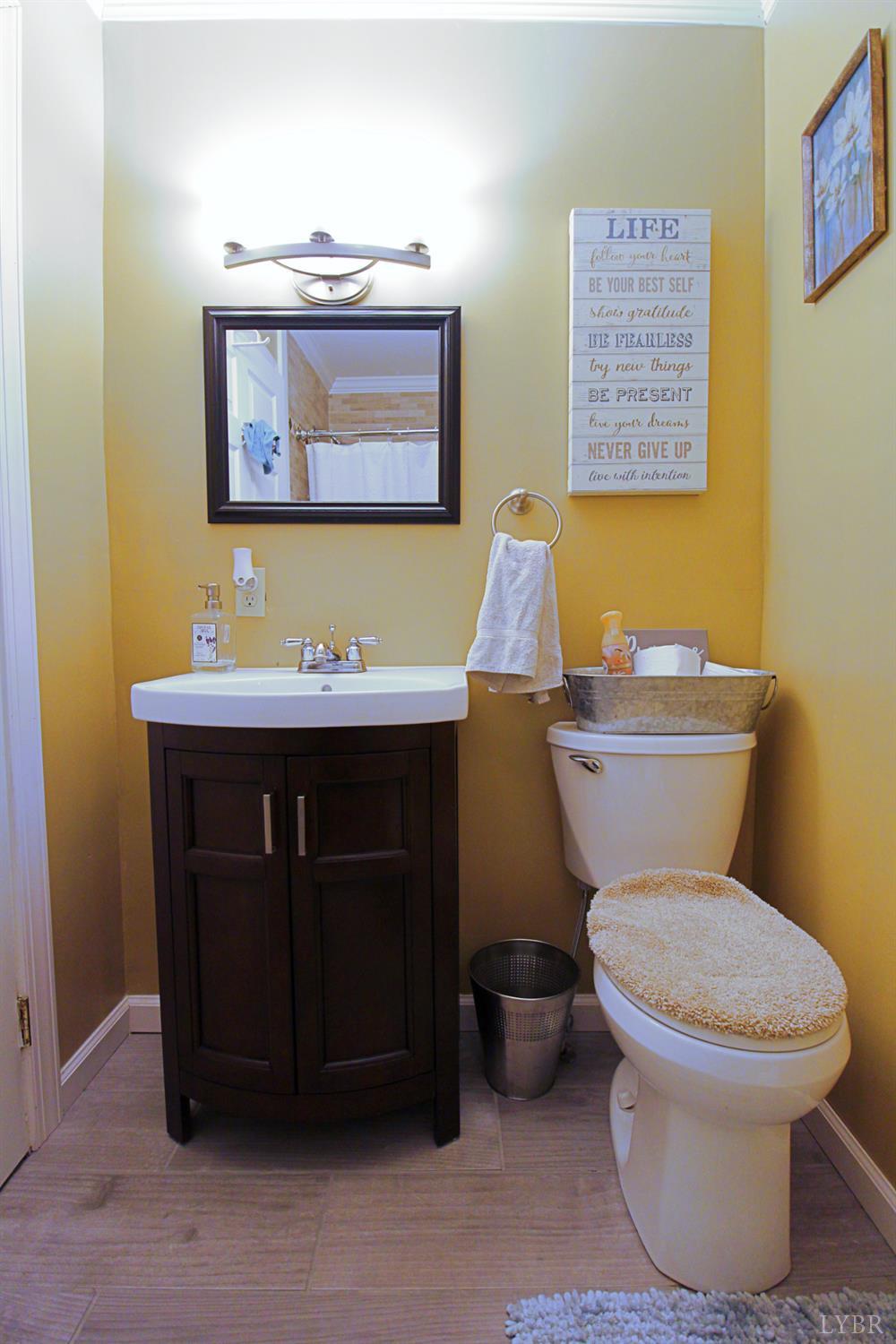 1147 Union Church Road Gladstone, VA 24553 - Photo 32 of 89 a bathroom with a toilet sink and mirror