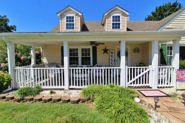 a view of a house with a backyard