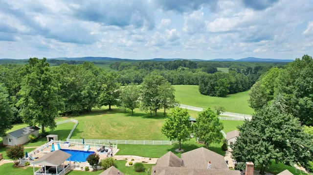 a view of a house with a backyard