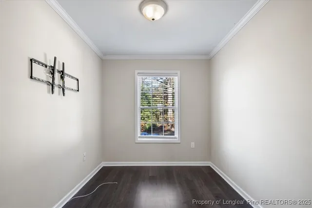 a view of a room with wooden floor and window