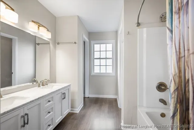 a bathroom with a double vanity sink and a mirror