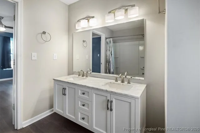 a bathroom with a granite countertop sink double and mirror