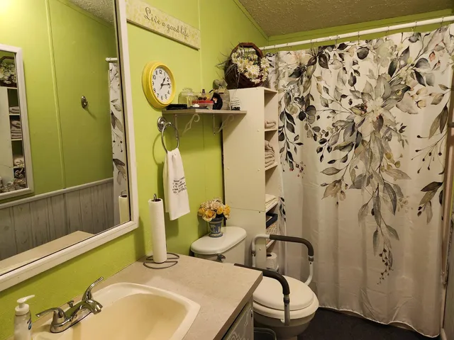 a bathroom with a sink and mirror with bathtub