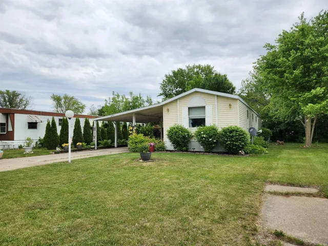 a view of a house with a yard and sitting area