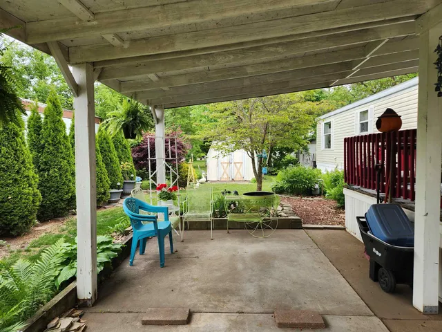 a view of a chairs and table in backyard