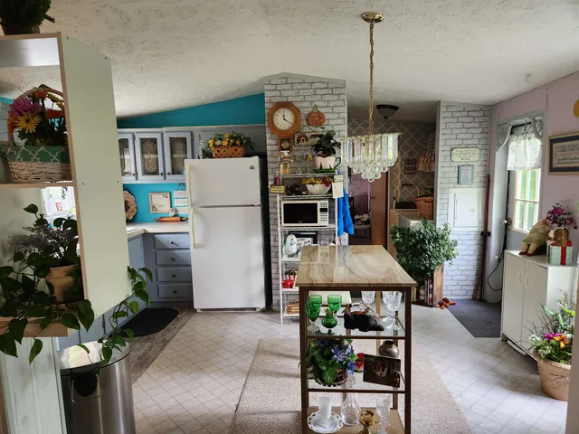 a dining room filled with furniture and a chandelier