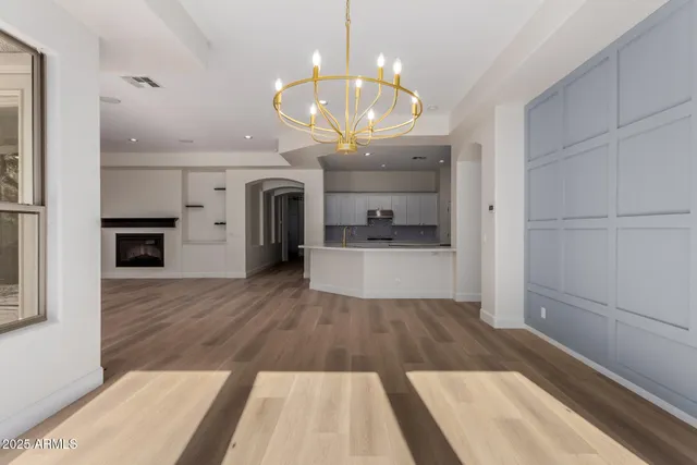 a living room with furniture and a kitchen