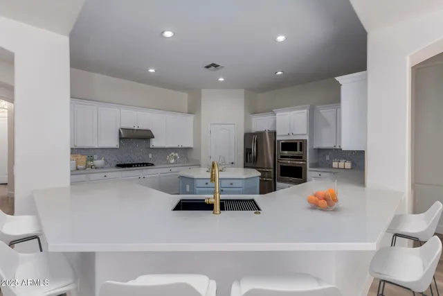 a kitchen with a sink a window and cabinets