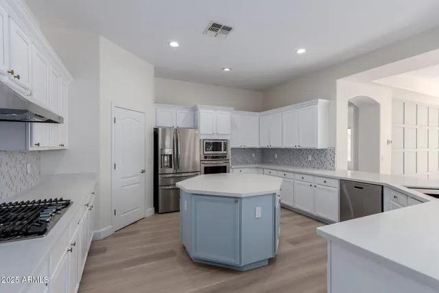 a kitchen with a sink stove and cabinets