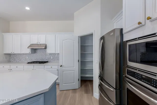 a bedroom with bed and a potted plant