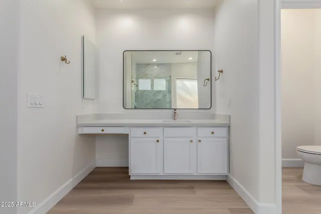 an empty room with a chandelier fan