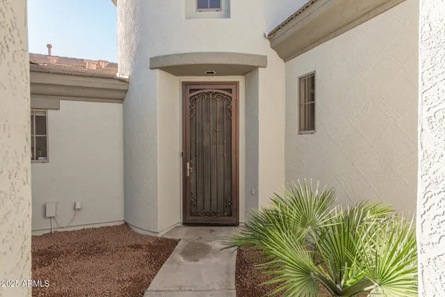 a view of a hallway with entryway and potted plants