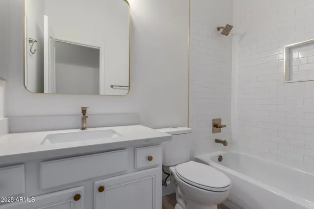 a view of a white house with a big yard and potted plants