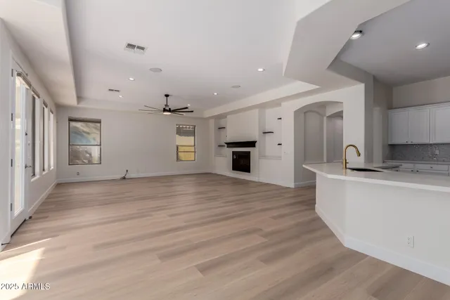 a living room with fireplace furniture and a wooden floor