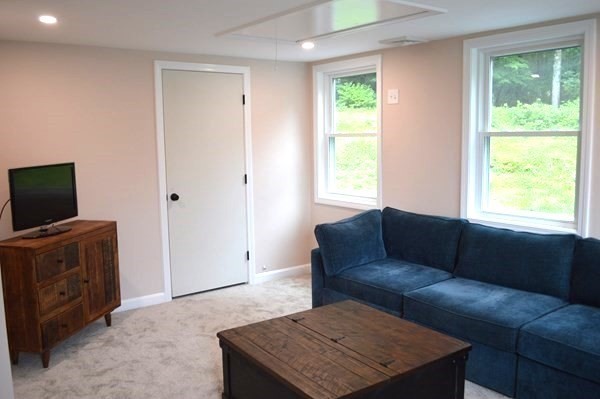 57 Indian Spring Road Ashland, MA 01721 - Photo 11 of 23 a living room with furniture and a flat screen tv