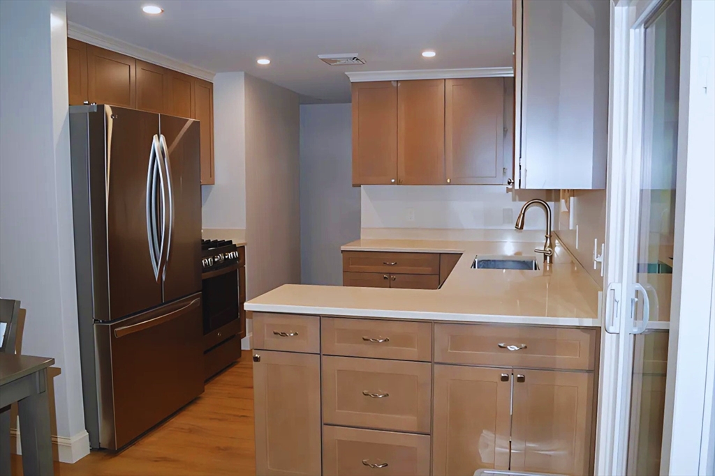 57 Indian Spring Road Ashland, MA 01721 - Photo 3 of 23 a kitchen with a refrigerator and a sink