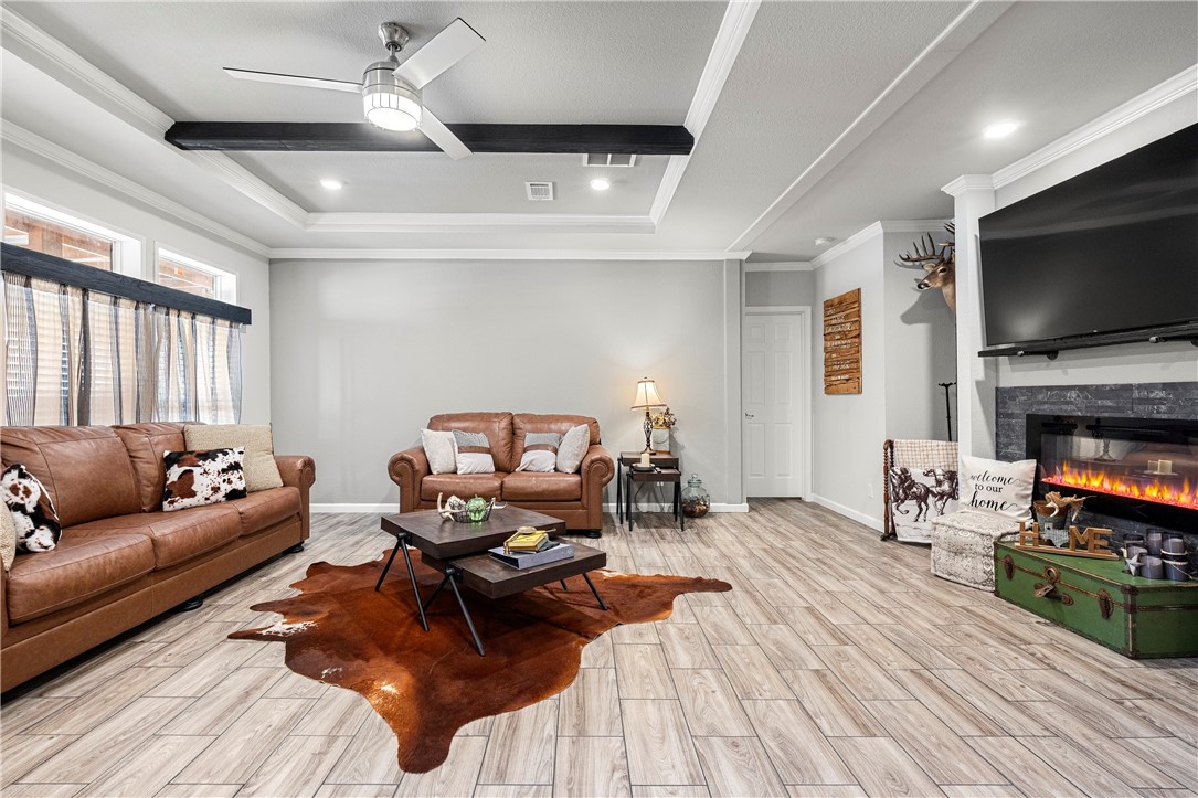7017 County Road 2253 Odem, TX 78370 - Photo 12 of 40 a living room with furniture and a flat screen tv