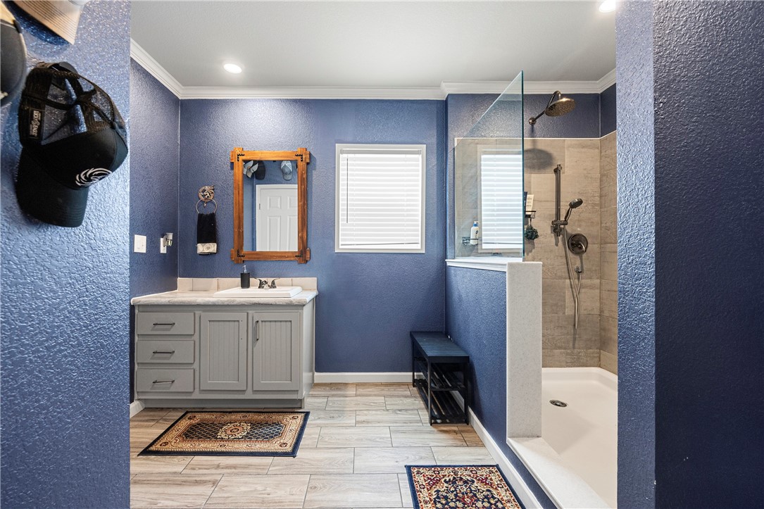 7017 County Road 2253 Odem, TX 78370 - Photo 23 of 40 a bathroom with a sink a toilet a mirror and shower