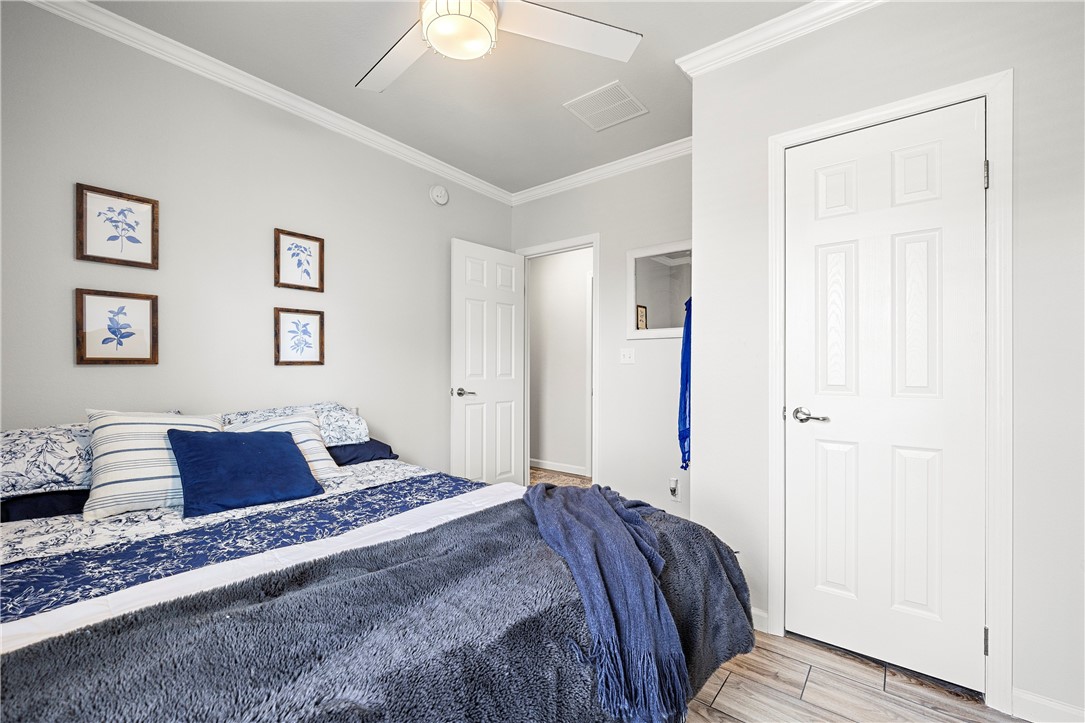 7017 County Road 2253 Odem, TX 78370 - Photo 25 of 40 a bedroom with a large bed and a couch