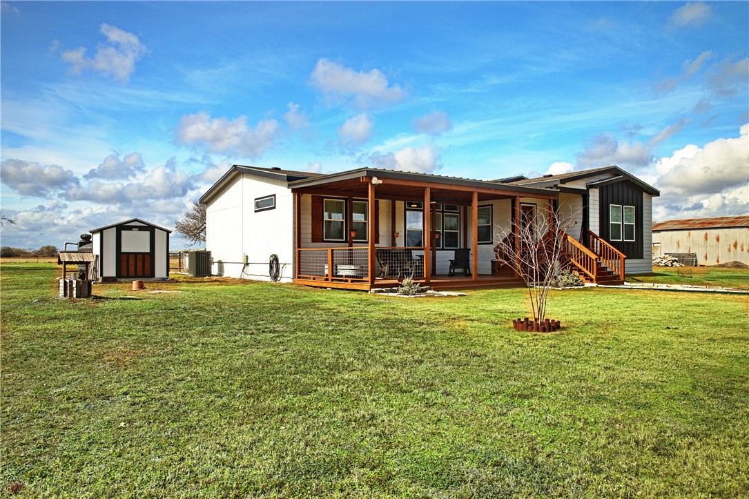 7017 County Road 2253 Odem, TX 78370 - Photo 4 of 40 a view of a house with a yard patio and a tree