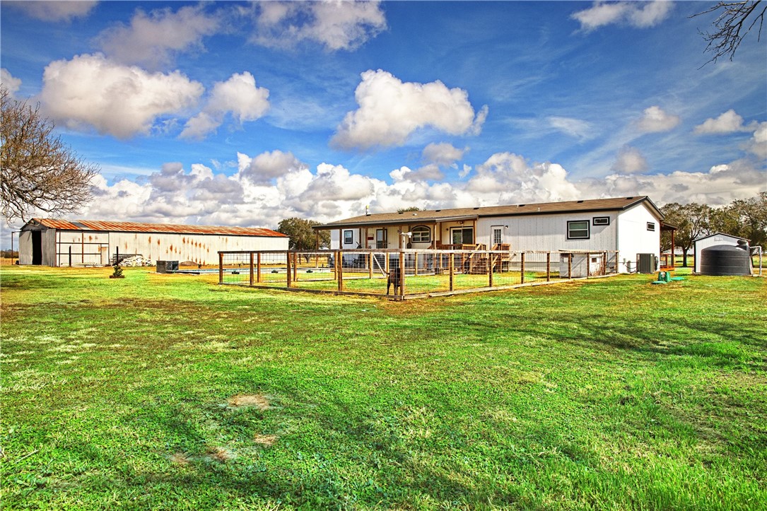 7017 County Road 2253 Odem, TX 78370 - Photo 7 of 40 a view of a house with a big yard