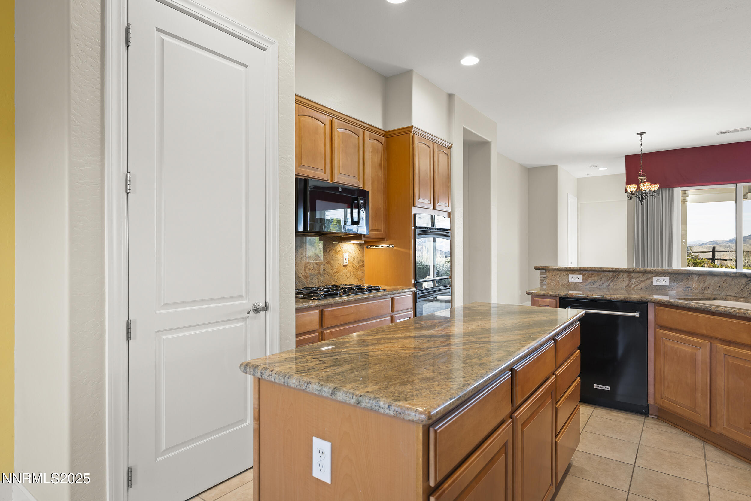 9190 Quilberry Way Reno, NV 89523 - Photo 11 of 39 a kitchen with stainless steel appliances granite countertop a sink stove and refrigerator