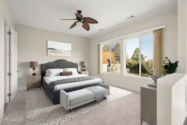 a bedroom with a large bed chandelier and a window