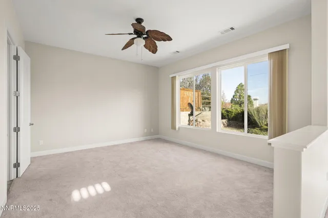 a view of room with a ceiling fan and window