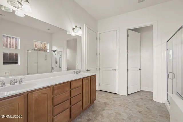 a bathroom with a double vanity sink mirror and double